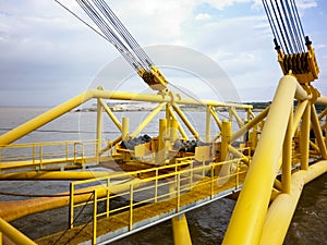 Laying of pipes with pipe-laying barge crane near the shore. Descent of the pipeline to a bottom exhausting with the pipelaying ba