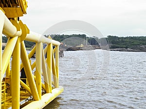 Laying of pipes with pipe-laying barge crane near the shore. Descent of the pipeline to a bottom exhausting with the pipelaying ba