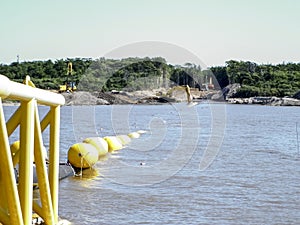 Laying of pipes with pipe-laying barge crane near the shore. Descent of the pipeline to a bottom exhausting with the pipelaying ba