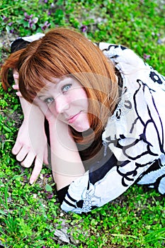 Laying spring redheaded girl photo