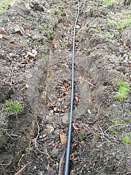 Laying of the sprinkler system of the pipeline in the ground trenches for the underground irrigation system, irrigation