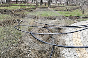 Laying of the sprinkler system of the pipeline in the ground trenches for the underground irrigation system, irrigation