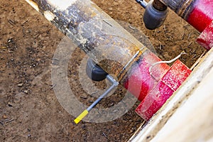 Laying of underground pipes in concrete chamber. Installation of water main at the construction site. Construction of stormwater