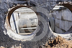 Laying of underground pipes in concrete chamber. Installation of water main at the construction site. Construction of stormwater