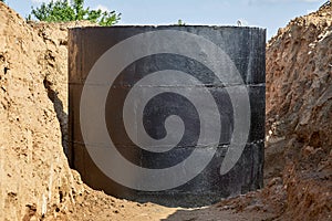 For laying water pipes in a trench with wooden stakes to indicate the direction and height, a concrete well covered with