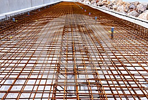 laying the welded mesh on a construction site before pouring the concrete