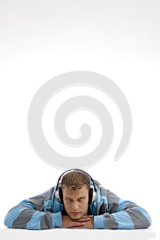 Laying young man with headphone