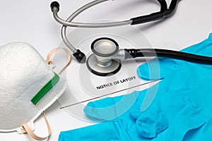 Layoff notice, medical equipment, gloves and stethoscope