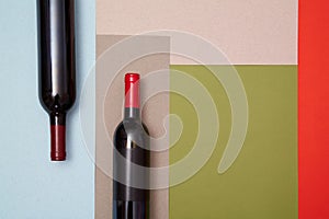 Layout of bottles of red wine on colorful paper background