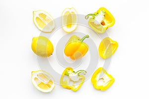 Layout made of lemons and yellow bell pepper. Food concept. Lemon pattern on white background top view copy space