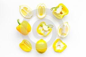 Layout made of lemons and yellow bell pepper. Food concept. Lemon pattern on white background top view copy space