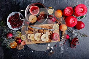 Layout of a pan with fruit sangria, a board with sliced apples, a plate with cranberries. Top view.