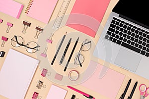 Layout of school equipment and laptop on a beige background