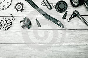 Layout of a set of car parts on a wooden white background. copy space