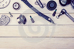 Layout of a set of car parts on a wooden white background. copy space