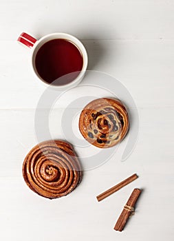 Layout for text, seasonal winter, autumn background. A cup with a hot drink and homemade buns. Flatlay on a light wooden