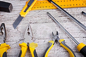 The layout of various construction tools of yellow and black colors. View from above.