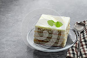 Layred lemon cake with jam on glass plate