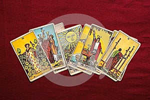 lays out tarot cards, candle, crystal on red background Flat lay Top view Fortune telling, prediction, esoteric, tarot cards