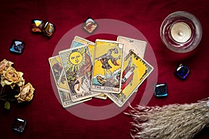 lays out tarot cards, candle, crystal on red background Flat lay Top view Fortune telling, prediction, esoteric, tarot cards