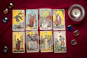 lays out tarot cards, candle, crystal on red background Flat lay Top view Fortune telling, prediction, esoteric, tarot cards