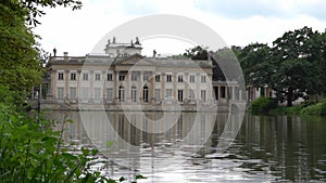 Lazienki Park with pond. Polish Lazienkowski or Lazienki Krolewskie is the polish park. The palace on the water is a