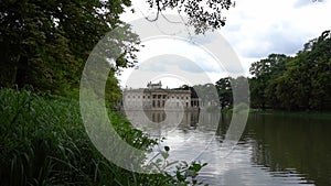 Lazienki Park with pond. Polish Lazienkowski or Lazienki Krolewskie is the polish park. The palace on the water is a