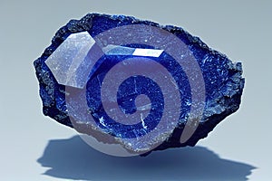 Lazurite & x28;lapis lazuli& x29; stone on on a light blue background.