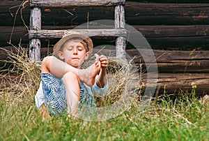 Lazy boy lies in grass under the barn - careless summer on count