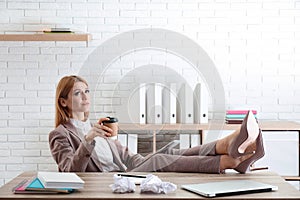 Lazy employee using tablet while resting at table