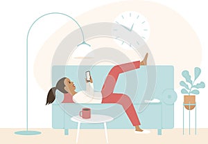 Lazy girl lying on a sofa using smartphone. Chatting in social media, procrastination. Concept for coronavirus COVID-19 quarantine photo