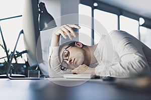 Lazy office worker sleeping at his desk