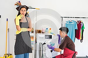 Lazy woman laugh while man laundry  alone