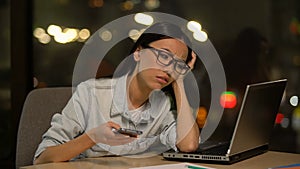 Lazy woman using cell phone at workplace, shirking boring job, distraction