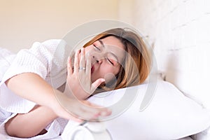 Lazy woman yawning on bed and tired sleepy,Female having symptoms sleepiness