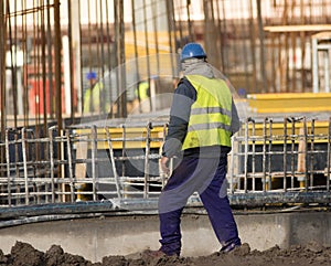 Slacker is walking with cigarettes through the construction sit photo