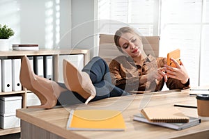 Lazy worker at wooden desk photo