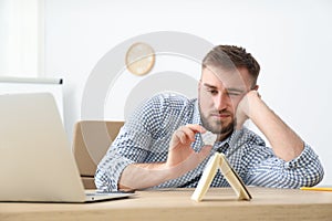 Lazy office employee procrastinating at workplace photo