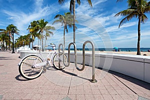 A lbike parked next to t Fort Lauderdale Beach