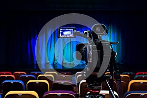 The LCD display on the camcorder. Shooting theatrical performances. The TV camera. Colorful chairs in the auditorium