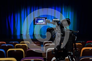 The LCD display on the camcorder. Shooting theatrical performances. The TV camera. Colorful chairs in the auditorium