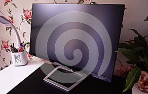 LCD IPS Monitor for home computer, desktop with a personal computer and a monitor with a large diagonal.
