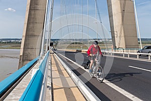 Cyclist at Pont de Normandie, French bridge over river Seine