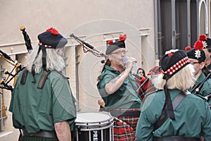 LE MANS, FRANCE - JUNE 13, 2014: Scottish bagpipe band is marching down the street during parade of pilots racing.