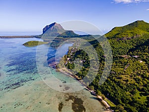 Le Morne beach Mauritius,Tropical beach with palm trees and white sand blue ocean and beach beds with umbrella,Sun