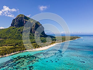 Le Morne beach Mauritius,Tropical beach with palm trees and white sand blue ocean and beach beds with umbrella,Sun