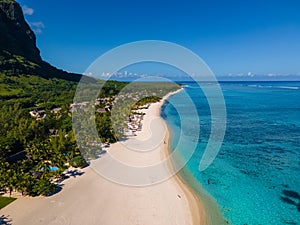 Le Morne beach Mauritius,Tropical beach with palm trees and white sand blue ocean and beach beds with umbrella,Sun