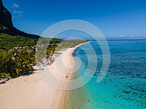 Le Morne beach Mauritius,Tropical beach with palm trees and white sand blue ocean and beach beds with umbrella,Sun