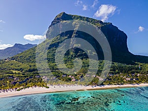 Le Morne beach Mauritius,Tropical beach with palm trees and white sand blue ocean and beach beds with umbrella,Sun