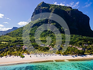 Le Morne beach Mauritius,Tropical beach with palm trees and white sand blue ocean and beach beds with umbrella,Sun